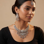 Aria Silver Necklace Set detail showing central floral polki motif and pear-shaped dangling stone charms