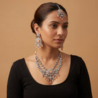 Aria Peach Necklace Set detail showing peach cabochon center, crystal floral border, and teardrop bead fringe