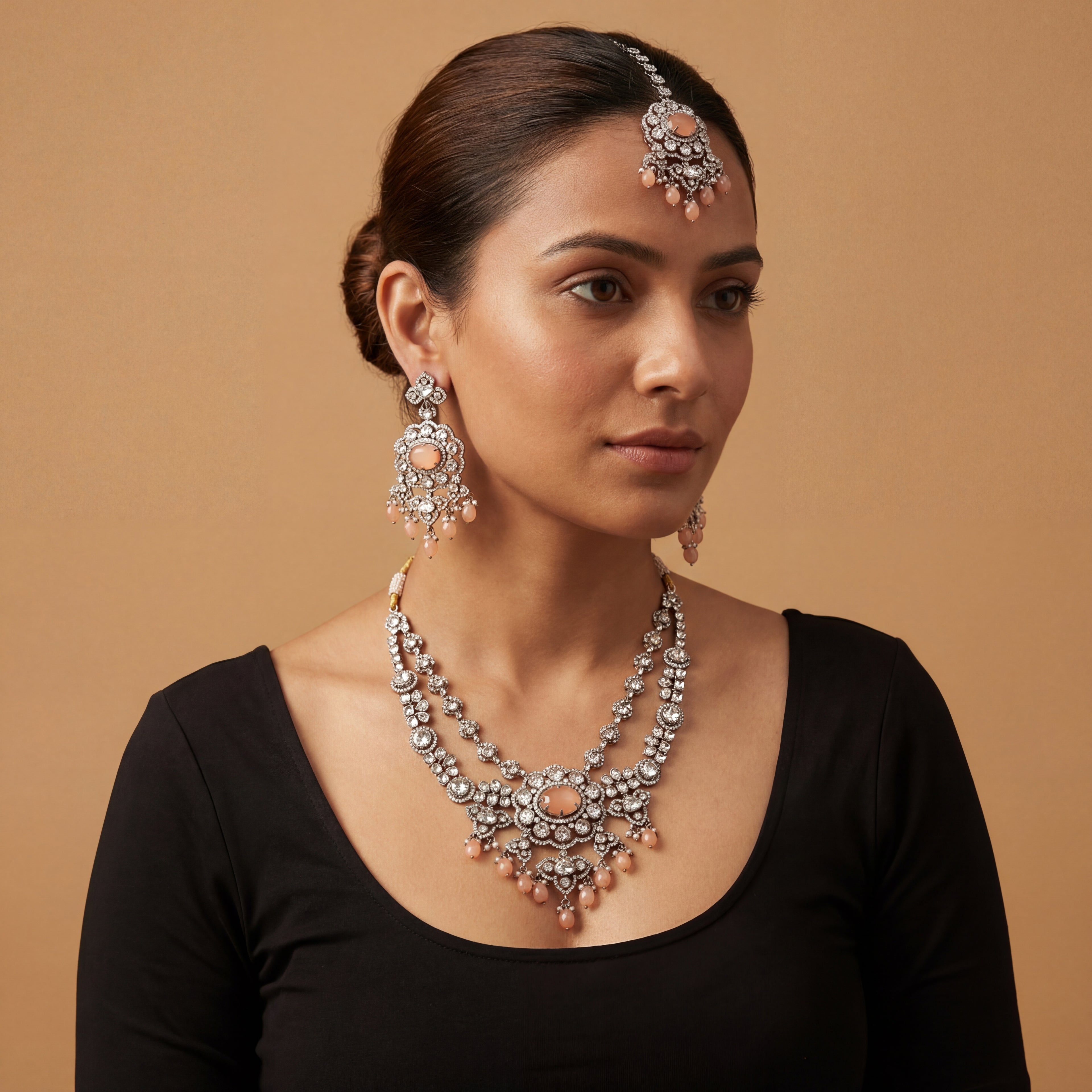 Aria Peach Necklace Set detail showing peach cabochon center, crystal floral border, and teardrop bead fringe