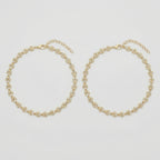 Gilded Leaf Crystal Anklets pair of gold-tone pavé leaf payals on gray background
