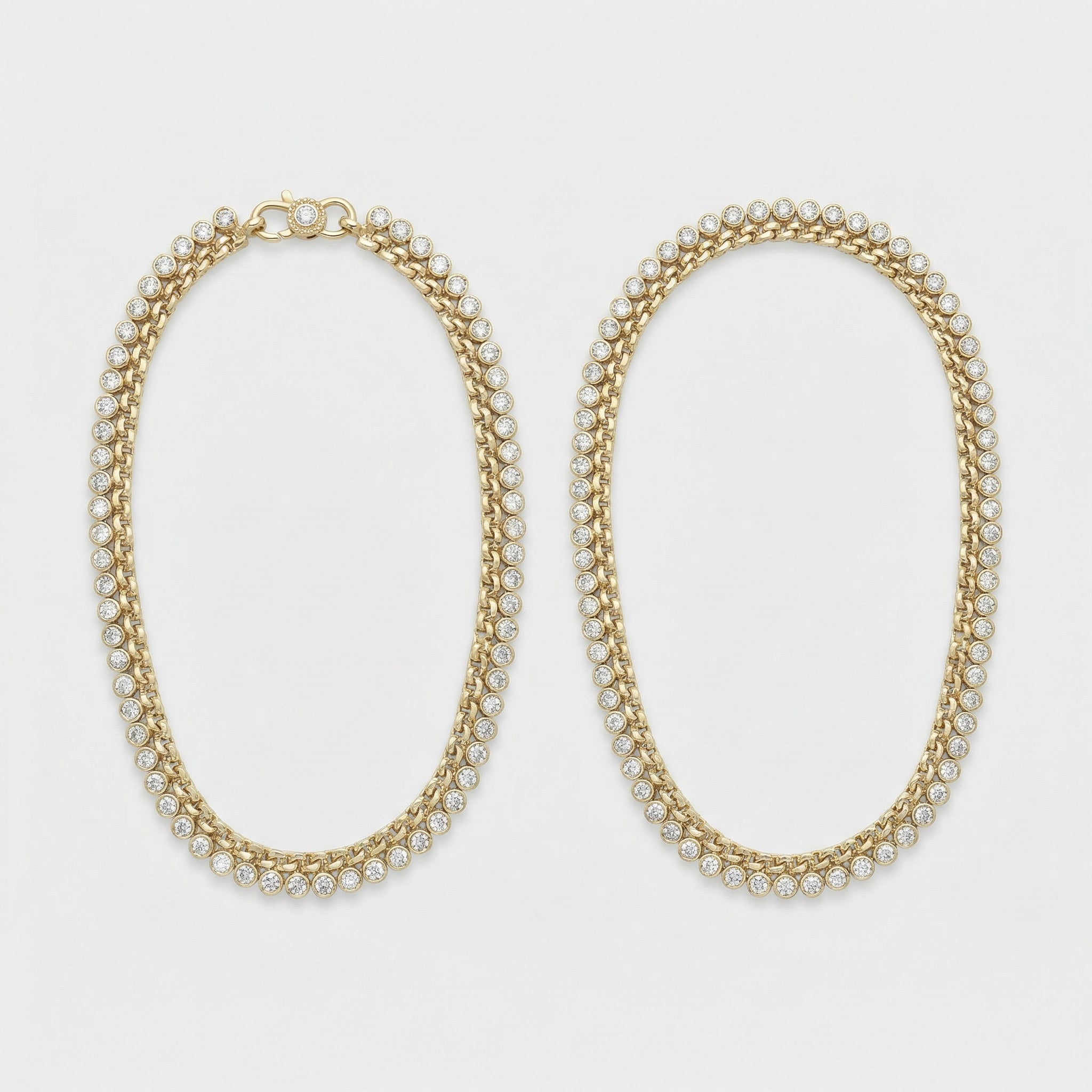 Radiant Gold Tennis Anklets pair of gold-tone double-row crystal payals on curb chain on gray background