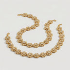 Gilded Blossom Anklets detail showing six-petal flower links and pavé centers