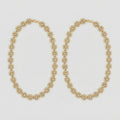 Gilded Blossom Anklets pair of gold-tone floral crystal payals on gray background
