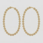 Gilded Blossom Anklets pair of gold-tone floral crystal payals on gray background