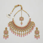 Detail flatlay of the silver-tone pink choker and matching earrings with pink petal accents