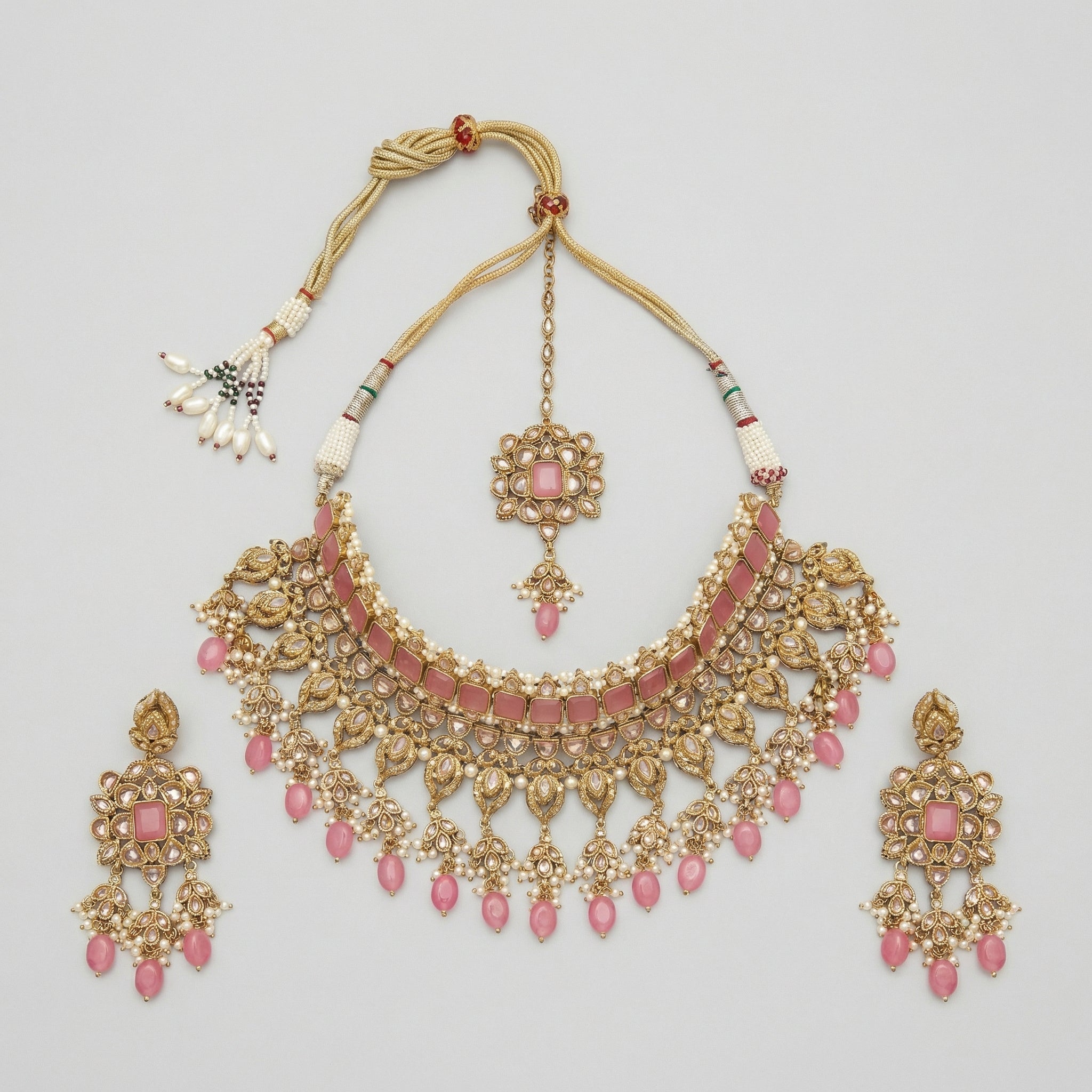 Detail flatlay of the silver-tone pink choker and matching earrings with pink petal accents