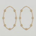 Gilded Kundan Anklets pair of gold-tone halo oval payals with pavé crystal chain on gray background