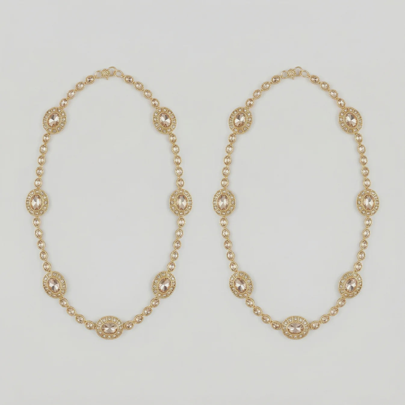 Gilded Kundan Anklets pair of gold-tone halo oval payals with pavé crystal chain on gray background
