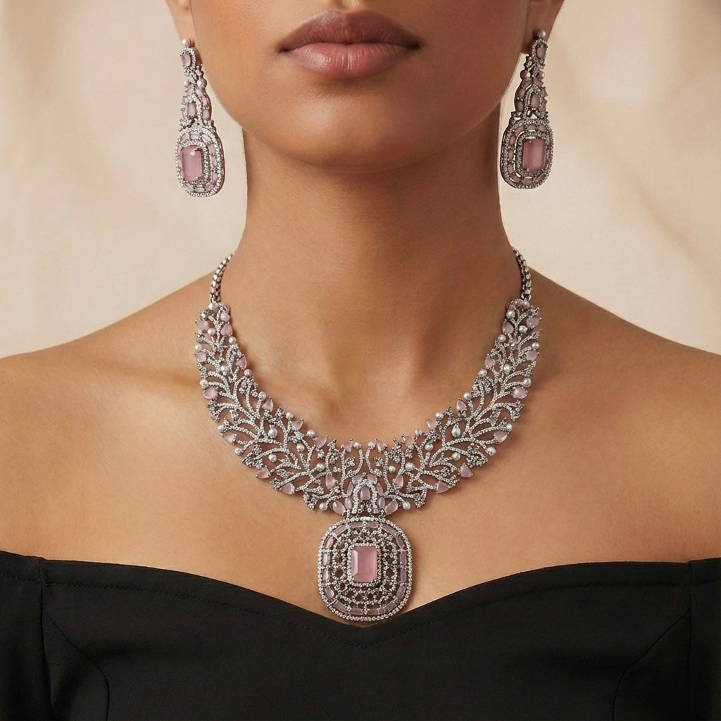 Studio flatlay of the silver-tone rose quartz necklace with matching earrings