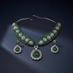 Close-up flatlay of Emerald Crest Statement Necklace Set necklace and matching earrings