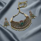 Detail flatlay of the silver-tone pearl choker and matching earrings with pearl accents