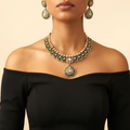 Emerald Kundan Necklace Set gold-plated necklace set with matching earrings in a studio flatlay