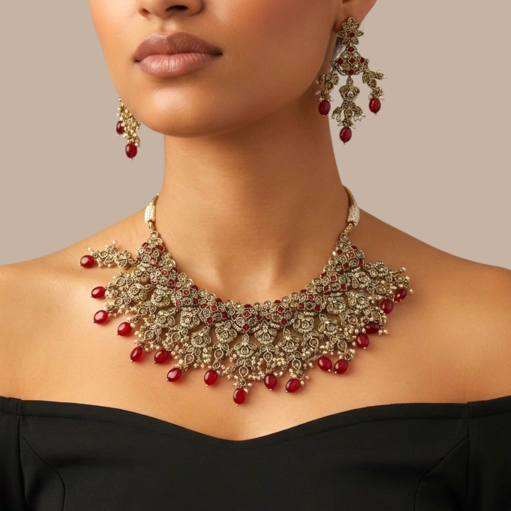 Studio flatlay of the ruby cascade necklace set with matching earrings.