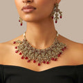 Studio flatlay of the ruby cascade necklace set with matching earrings.