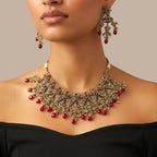 Studio flatlay of the ruby cascade necklace set with matching earrings.