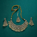 Detail flatlay of the white stone necklace set, highlighting the stonework and earrings.