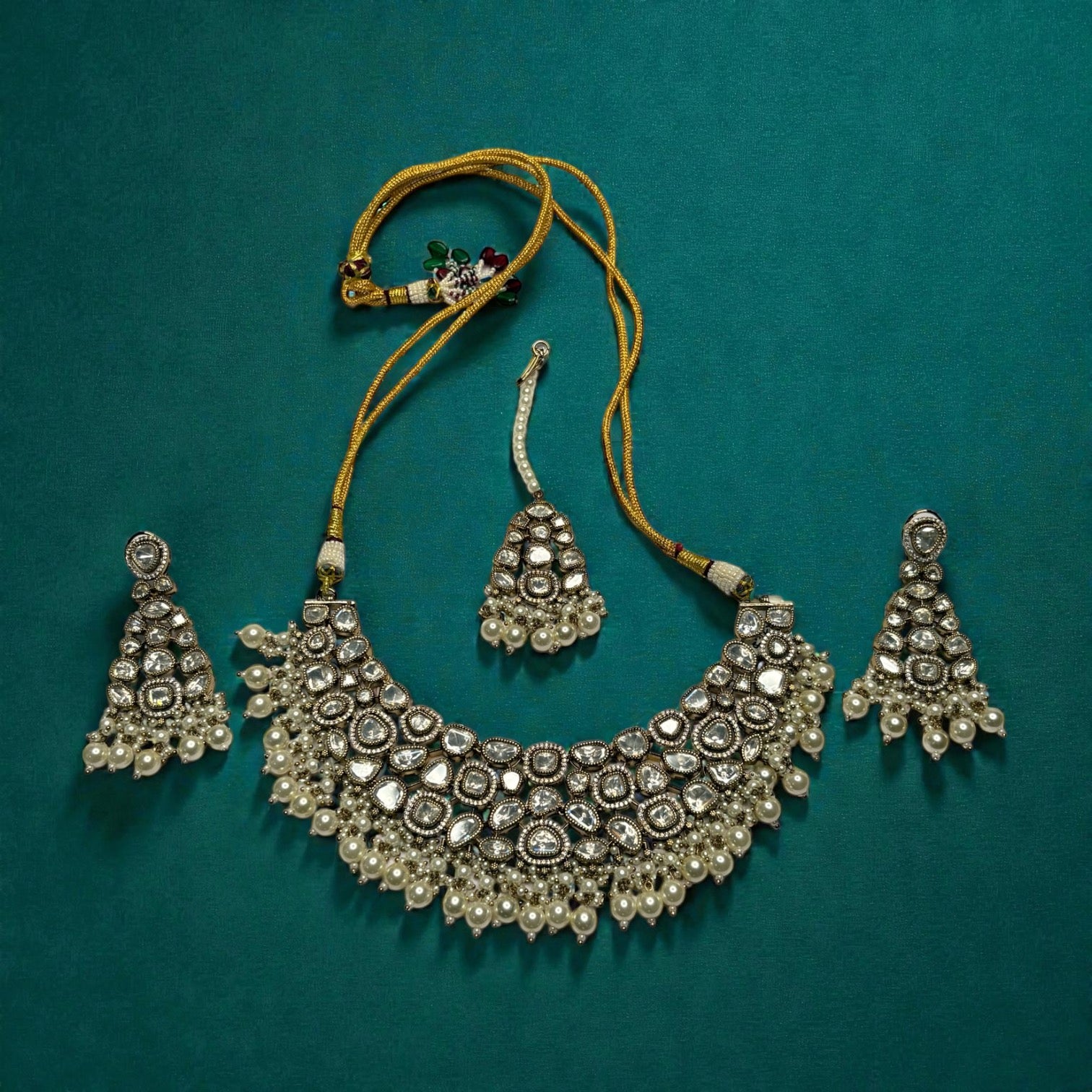 Detail flatlay of the white stone necklace set, highlighting the stonework and earrings.