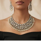 Studio flatlay of the white stone necklace set with matching earrings.