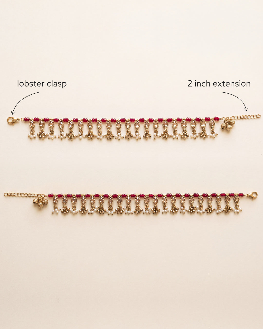 Bloom Drop red anklet pair laid flat, showing the lobster clasp and 2 inch extension chain