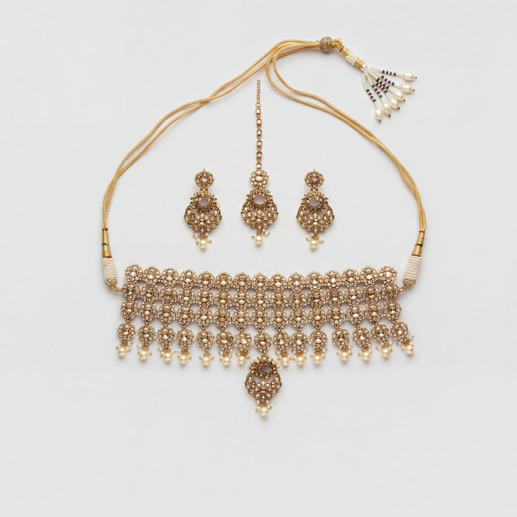 Zara Polki Necklace Set gold-tone polki choker with earrings and tikka on gray background
