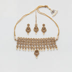 Zara Polki Necklace Set gold-tone polki choker with earrings and tikka on gray background