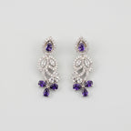 Pari Amethyst Earrings silver floral drops with purple pear stones and clear crystal pavé on gray background