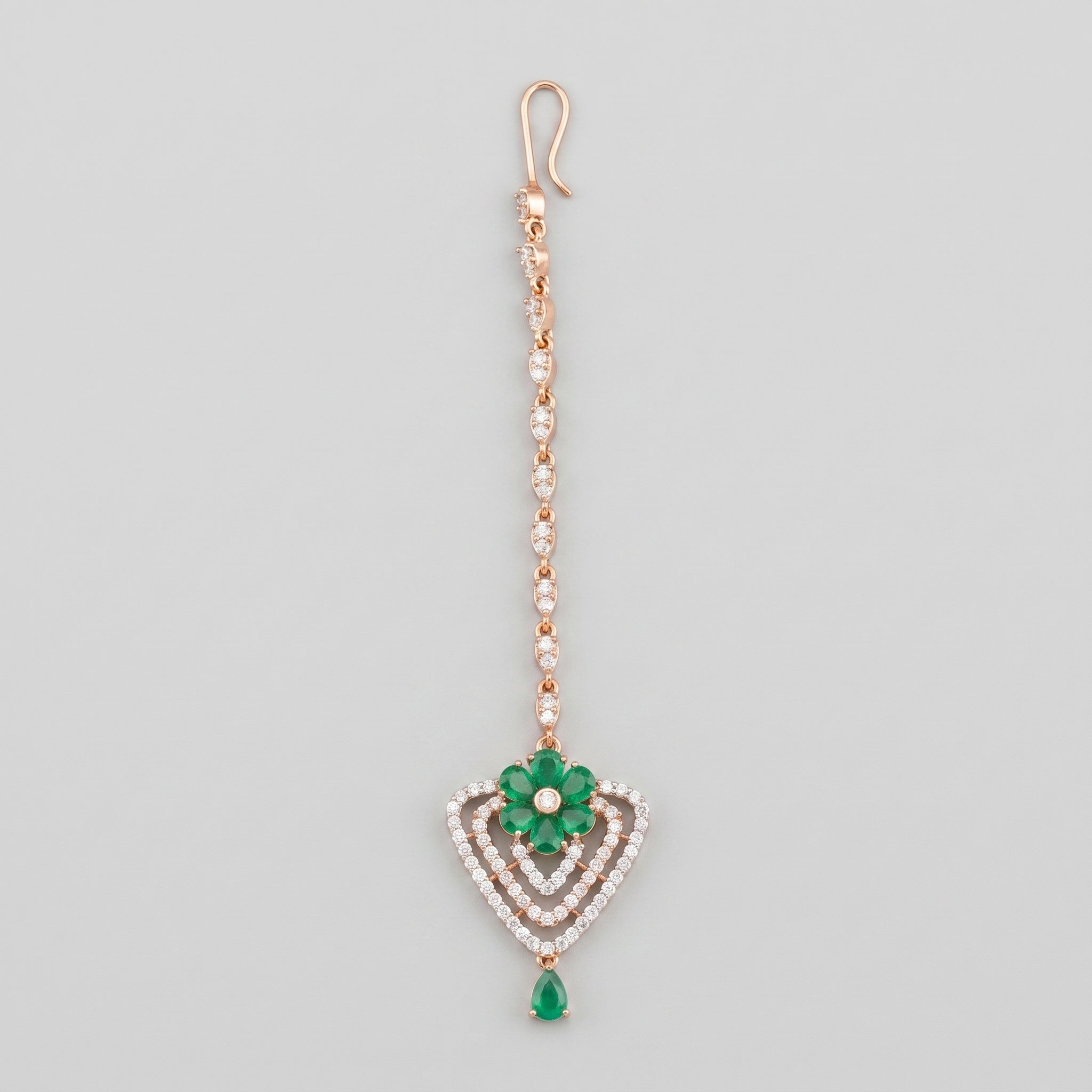 Pushpa Emerald Tikka rose gold-tone maang tikka with green floral heart pendant on gray background