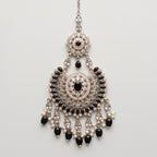 Onyx Pearl Tikka silver chaandbali maang tikka with black stones and pearl fringe on gray background