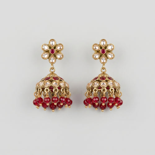 Amrita Ruby Earrings gold kundan jhumkas with ruby and clear stones on gray background