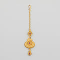 Priya Ruby Tikka matte gold maang tikka with ruby-pink stones on gray background