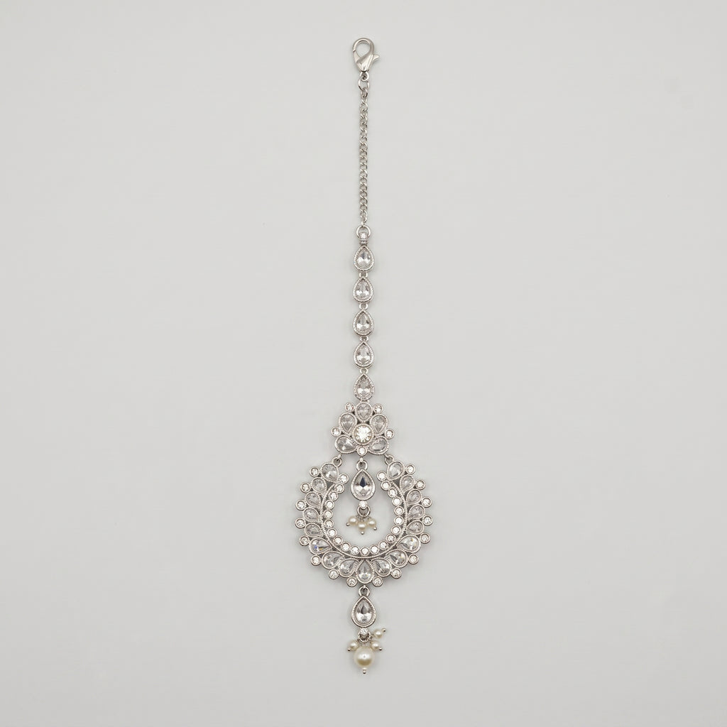 Rani Pearl Tikka silver-tone maang tikka with pearl drops and open circle pendant on gray background