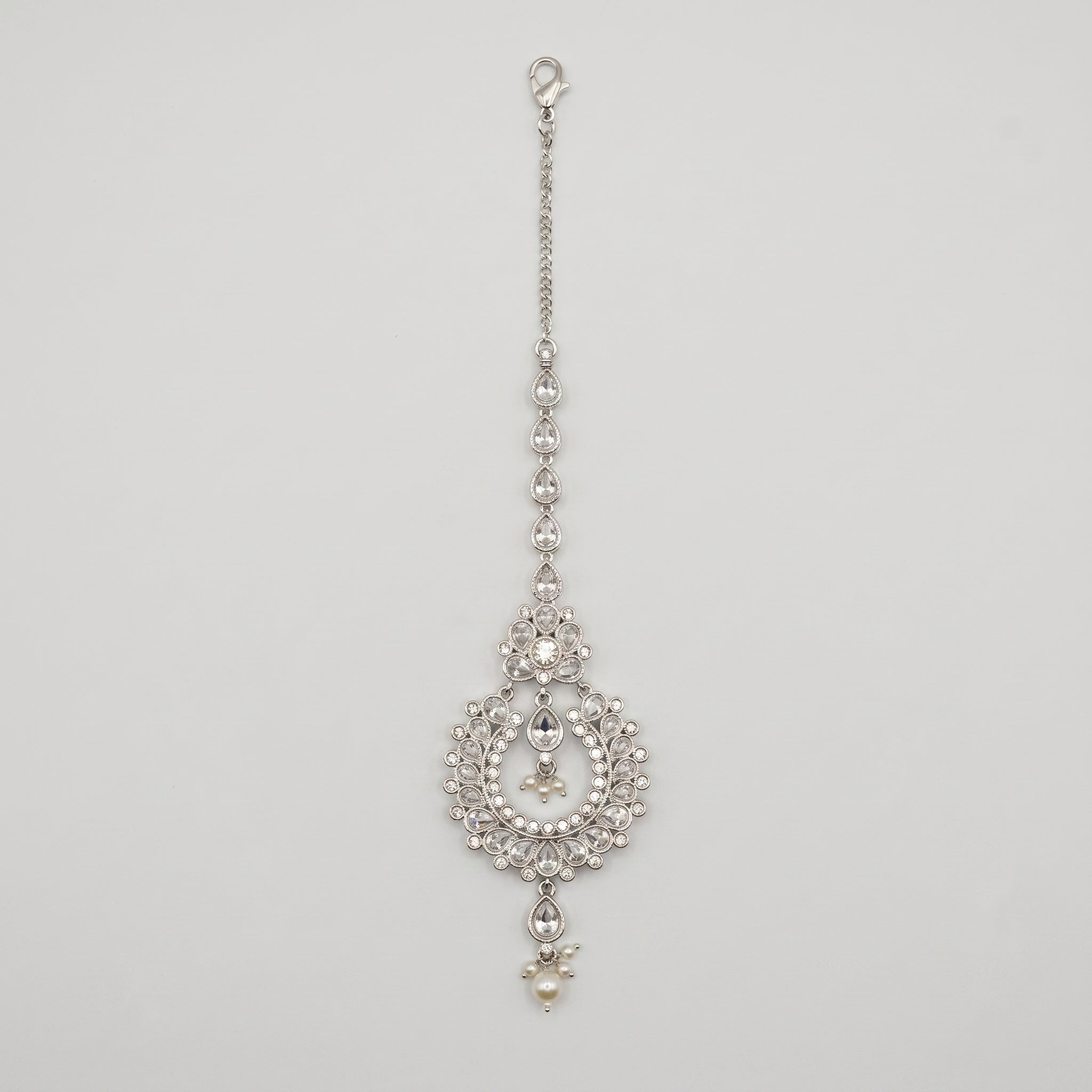 Rani Pearl Tikka silver-tone maang tikka with pearl drops and open circle pendant on gray background
