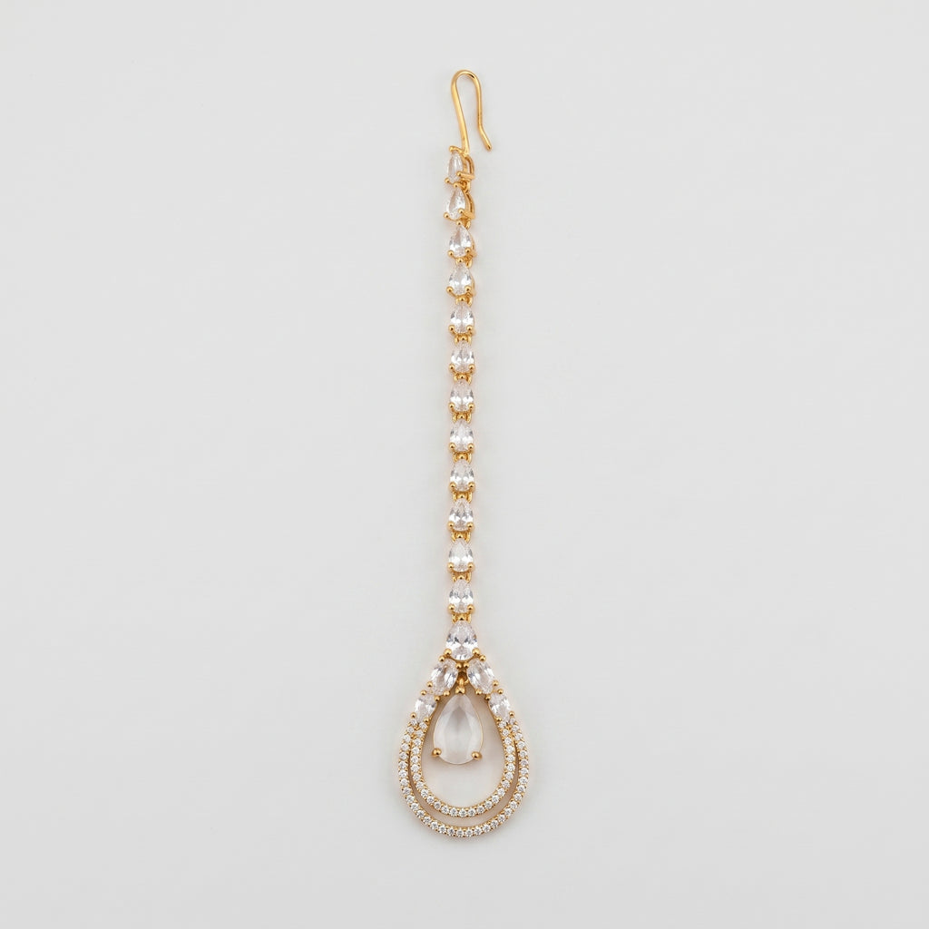 Aira Moonstone Tikka gold maang tikka with pear crystal chain and moonstone teardrop pendant on gray background