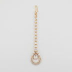 Aira Moonstone Tikka gold maang tikka with pear crystal chain and moonstone teardrop pendant on gray background