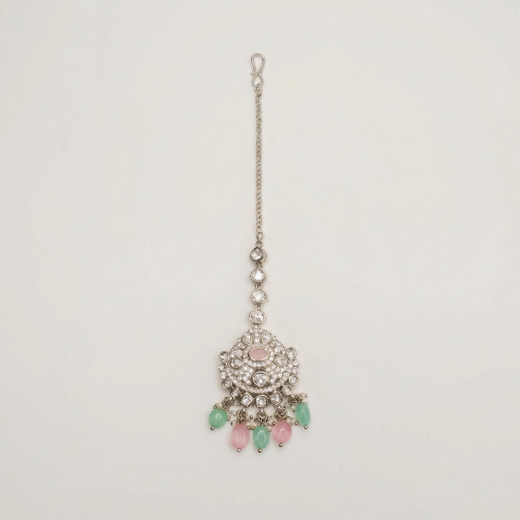 Mridul Tikka silver maang tikka with pink center and mint green pink teardrop beads on gray background