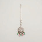 Mridul Tikka silver maang tikka with pink center and mint green pink teardrop beads on gray background
