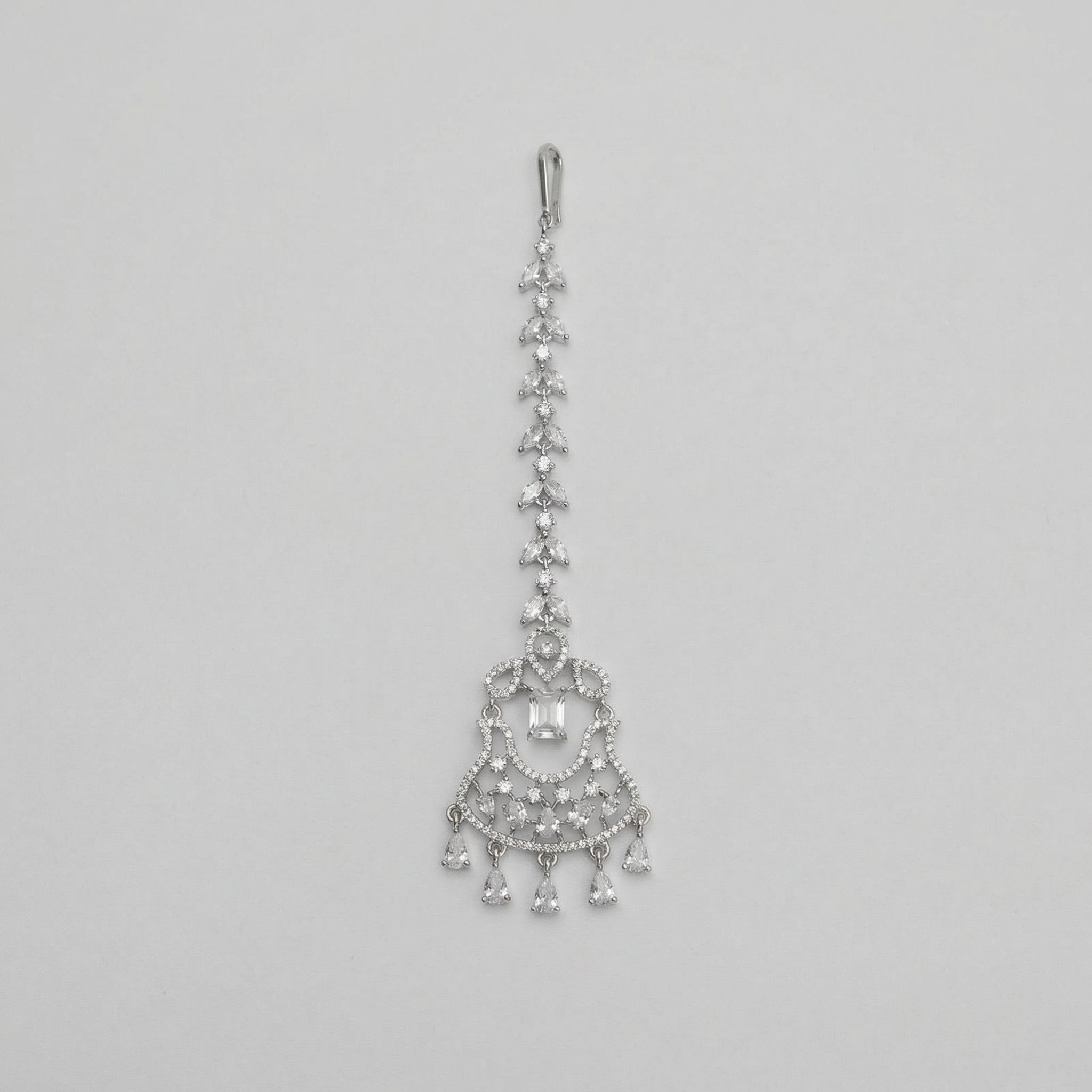 Crystal Drop Tikka silver maang tikka with marquise chain and emerald-cut center on gray background