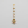 Emerald Star Tikka gold-tone maang tikka with green starburst pendant on gray background