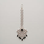 Zoya Onyx Tikka silver maang tikka with black and clear stones on gray background