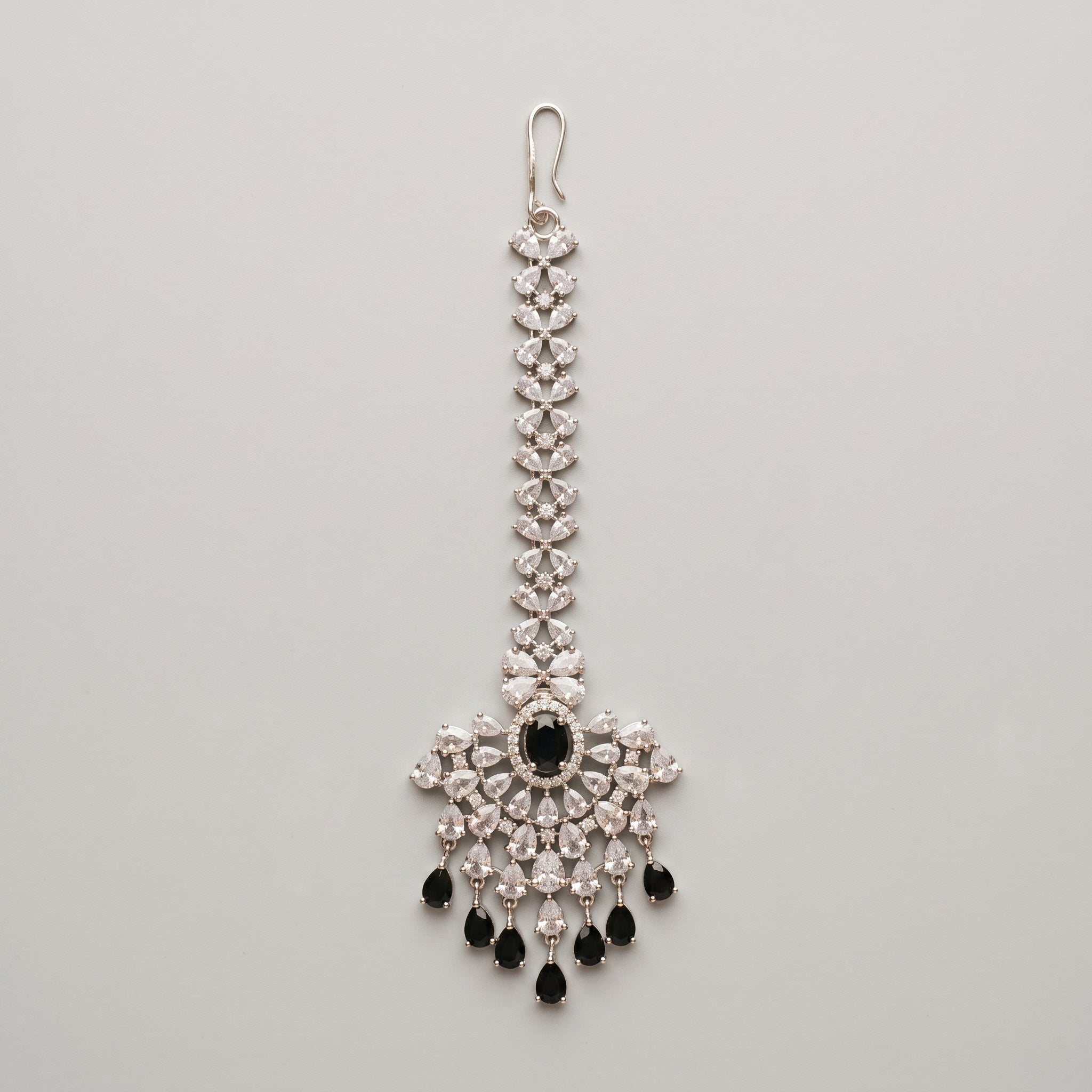 Zoya Onyx Tikka silver maang tikka with black and clear stones on gray background