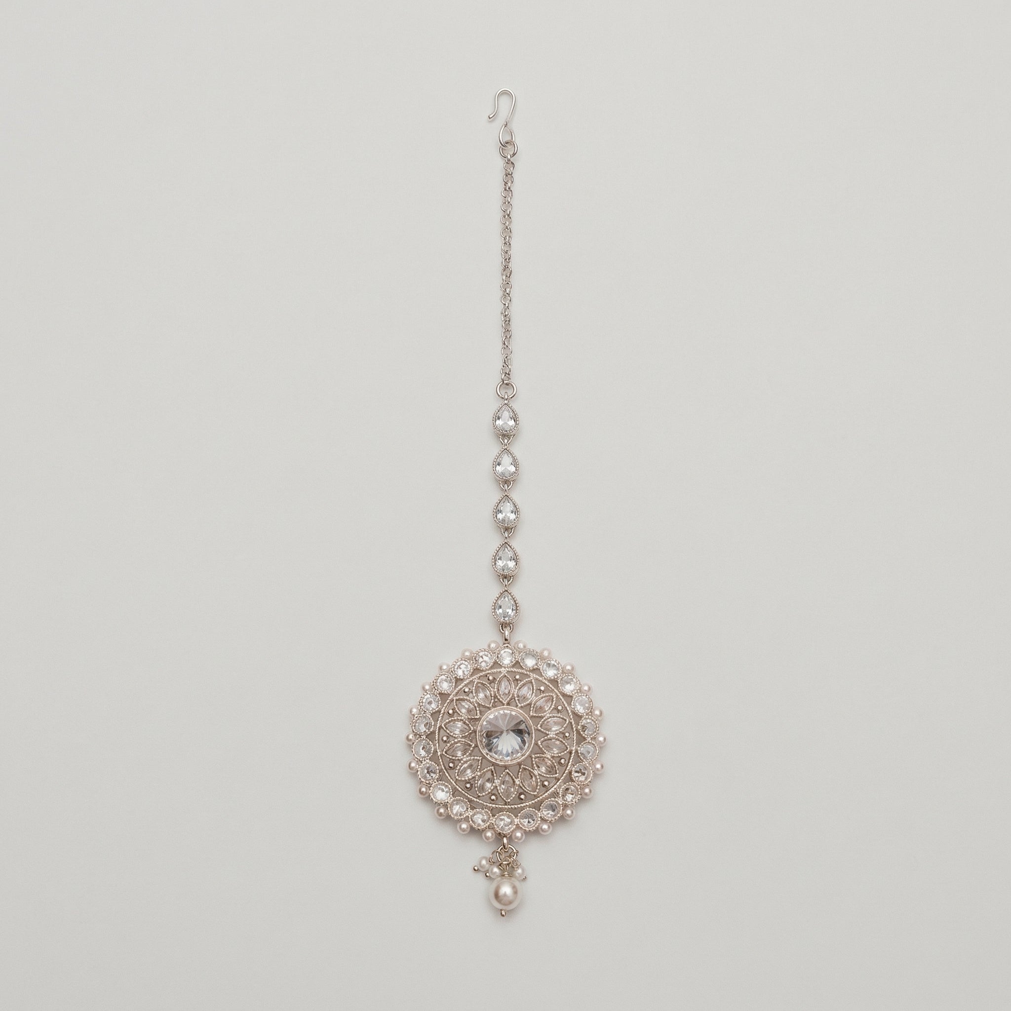Mandala Crystal Tikka silver maang tikka with mandala round pendant clear crystals and pearl border on gray background