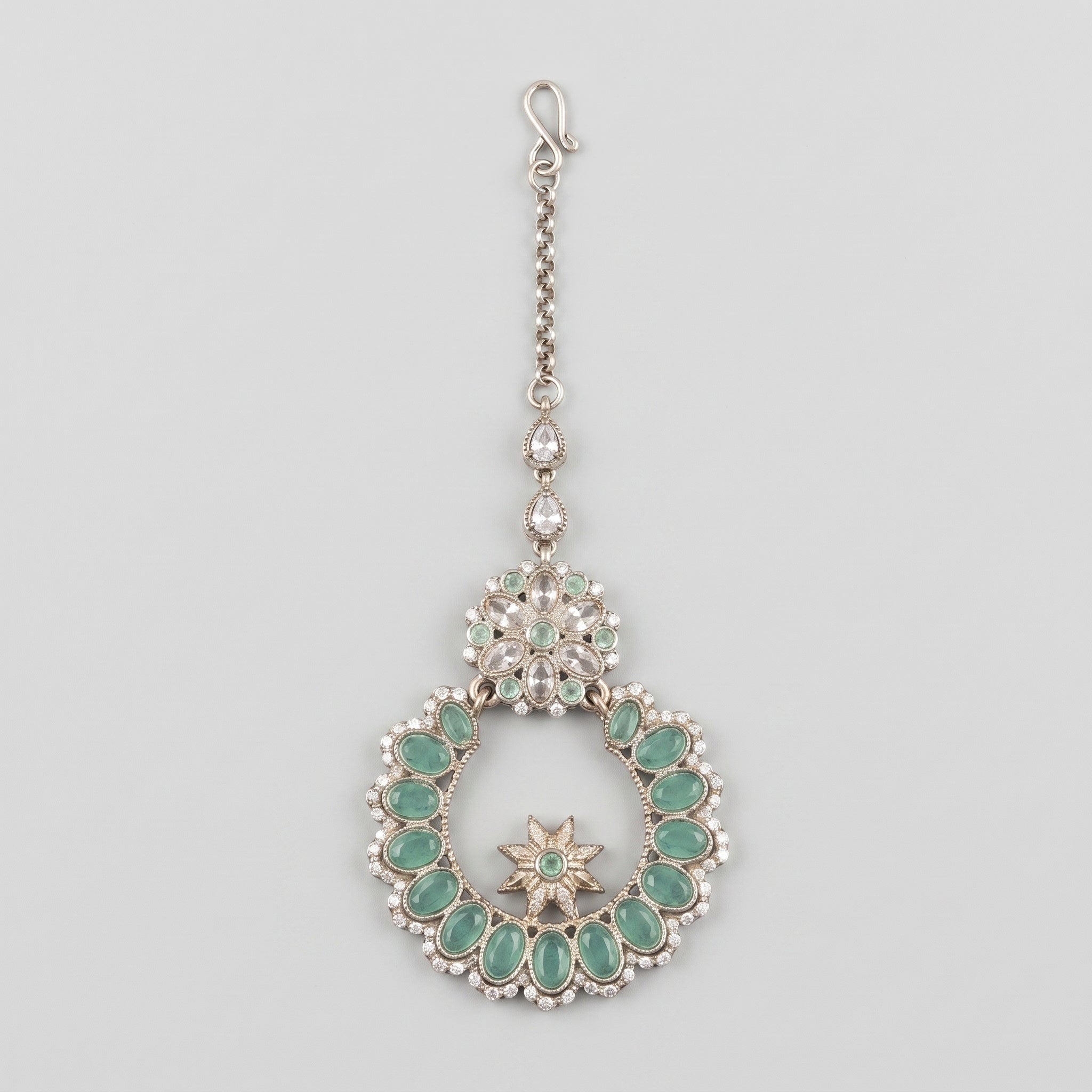 Aqua Star Tikka silver maang tikka with mint green wreath pendant on gray background