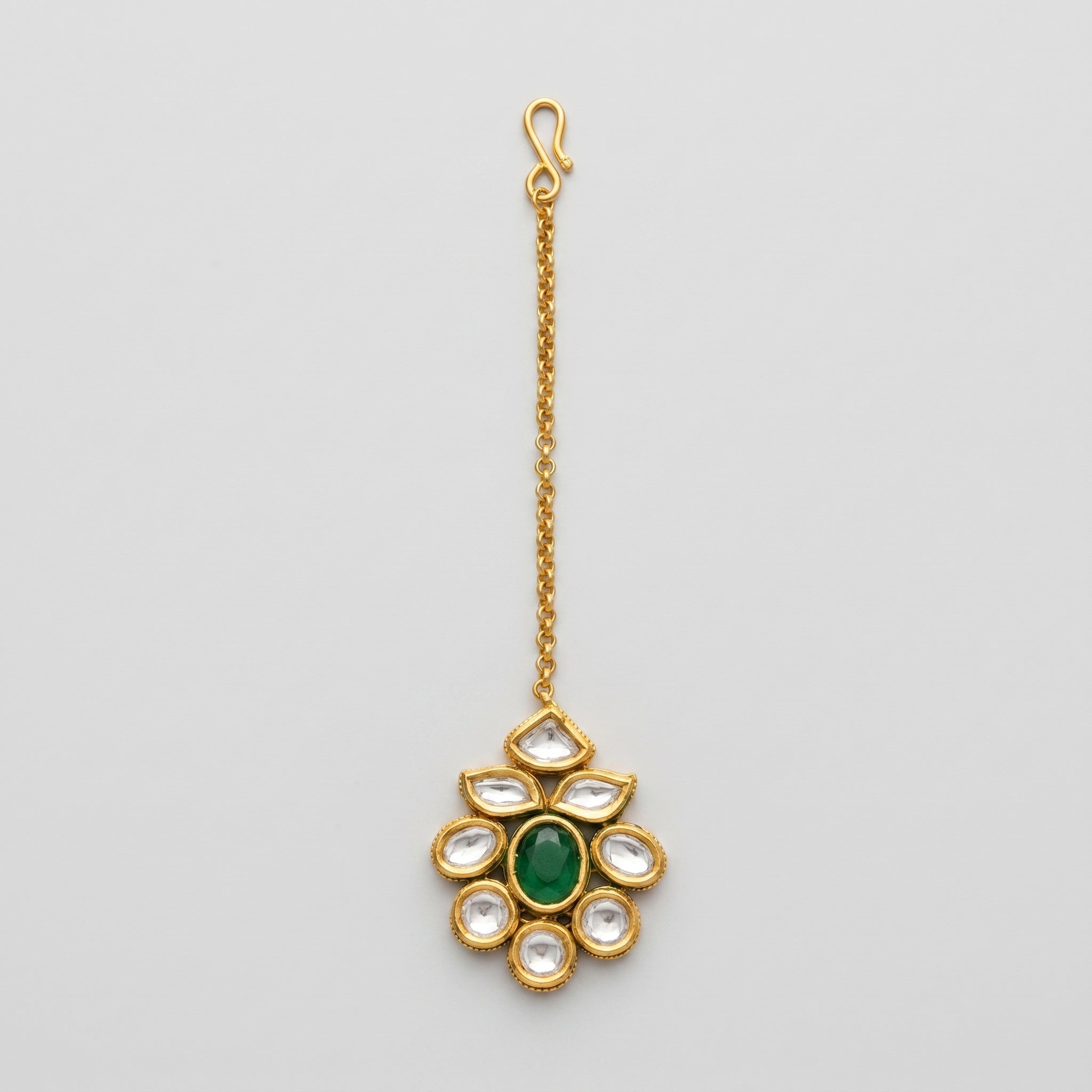Panna Jadau Tikka gold jadau maang tikka with green center stone on gray background