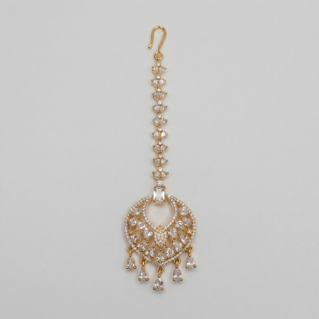 Amala Zircon Tikka gold maang tikka with marquise crystal chain round medallion and pear drops on gray background