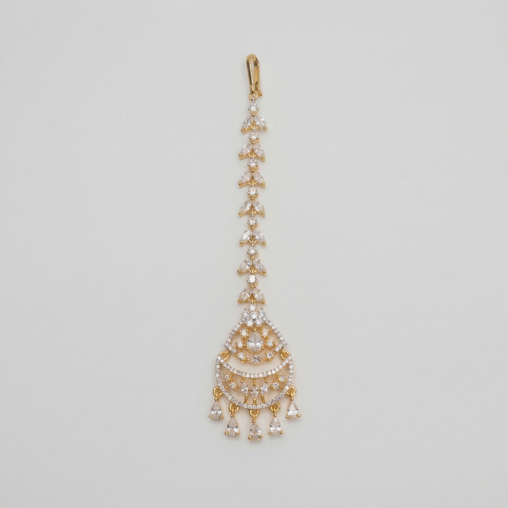 Kiara Dewdrop Tikka gold chandbali maang tikka with marquise crystal chain and teardrop dangles on gray background