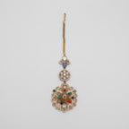 Navrang Tikka detail showing stacked medallions and oxidized gold scrollwork with colored stones