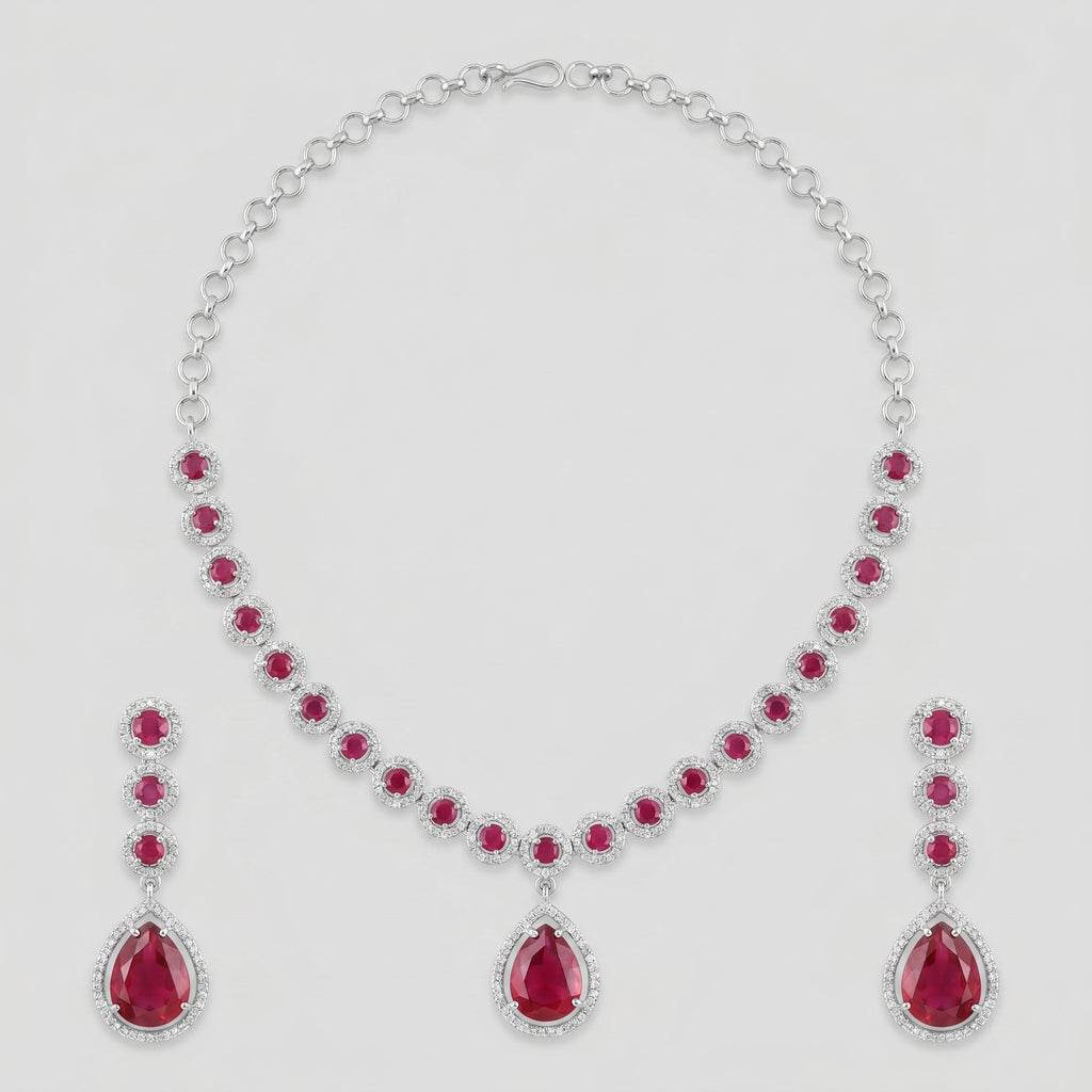Aira Ruby Necklace Set silver-tone ruby collar choker with matching drop earrings on gray background
