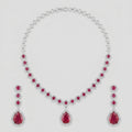 Aira Ruby Necklace Set silver-tone ruby collar choker with matching drop earrings on gray background