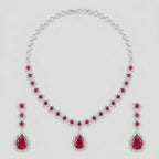 Aira Ruby Necklace Set silver-tone ruby collar choker with matching drop earrings on gray background