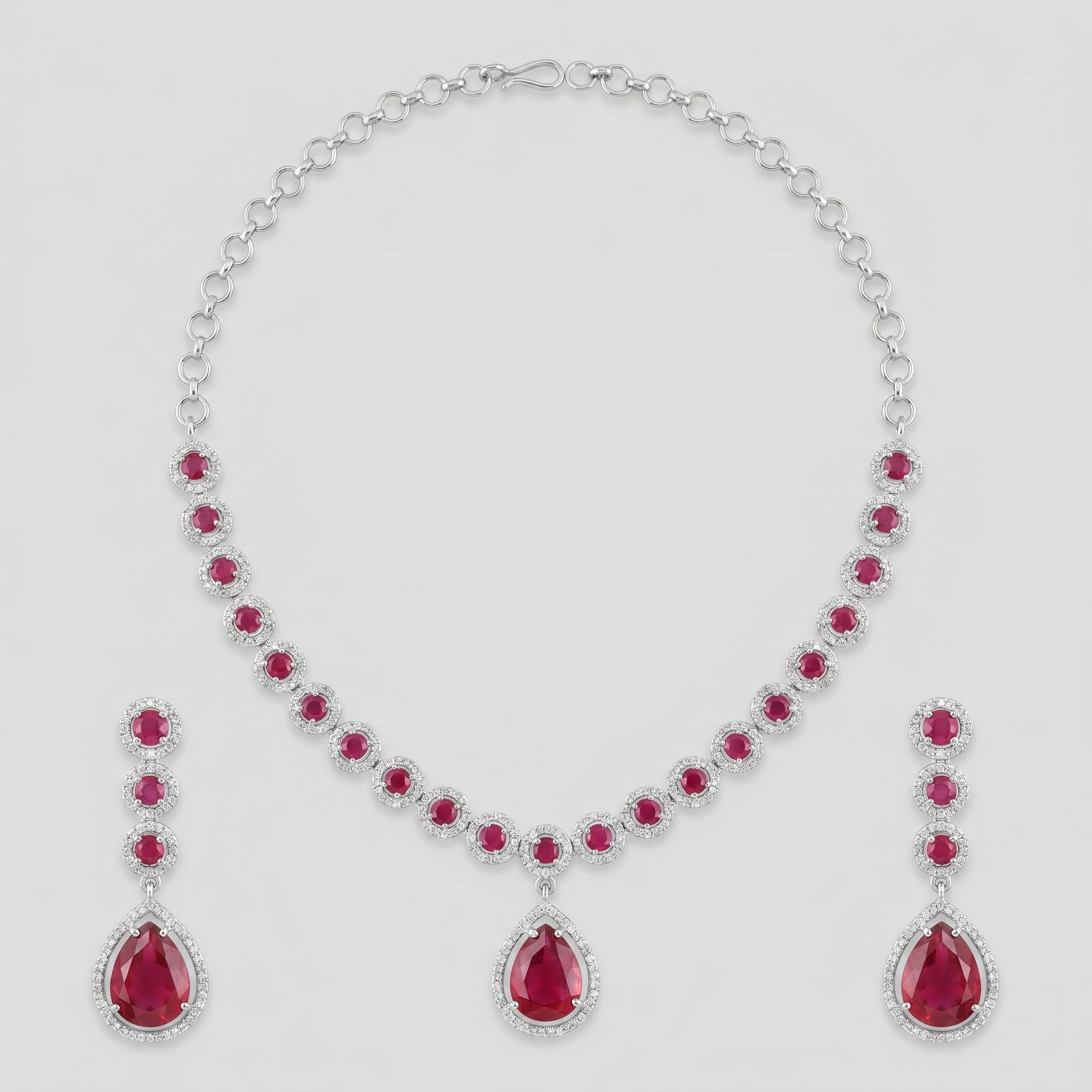 Aira Ruby Necklace Set silver-tone ruby collar choker with matching drop earrings on gray background